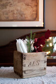 Candles and twigs in old wooden box carved with initials