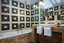 Mediterranean bathroom with pattern of black and white wall tiles