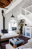 View of day bed and fireplace in open living room in former church