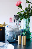 Glassware and flowers on table