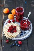 Homemade berry jam with apricots and cherries