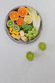Green smoothies and ingredients on a white background (seen from above)