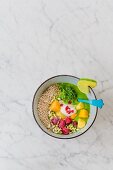 A wild herb smoothie bowl with popped amaranth and frozen fruits