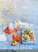 Rosé with rosemary and peach and a Papaya Freezer served with crostini with ham and melon tartare, courgette rolls with ricotta and smoked salmon and a rocket frittata with tomatoes