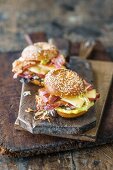 A sesame bagel with BBQ meat and mountain cheese