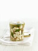 Lacto fermented garlic with sage and thyme in a mason jar
