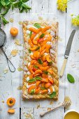 Puff pastry tart with vanilla creame cheese, fresh apricots and honey