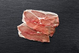 Two slices of raw dry-cured and smoked Westphalian ham