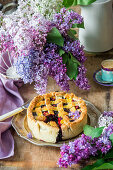 Blueberry pie surrounded by lilac