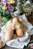 Fresh baguettes on a tea towel