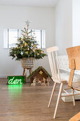 Christmas tree, nativity scene and green neon lettering