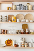 Retro crockery in shades of brown on kitchen shelves