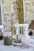 Candles and mulled wine on set table