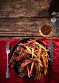 Sticky pork ribs with whiskey and maple syrup, served with sweet potato fries