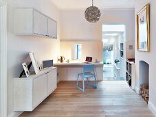 Fitted desk, wall-mounted cupboards and fireplace in study