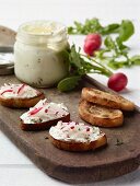 Radishes and sour cream spread on toasted bread