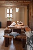 Rustic wooden furniture and wintry decorations in cabin parlour