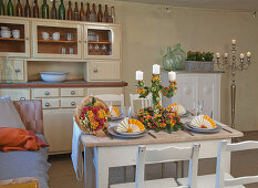 Country-house-style table decorated with flaming Katy