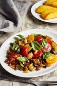 Caponata with peppers and cherry tomatoes served with polenta slices