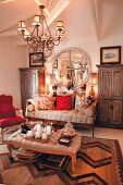 Upholstered furniture and red accents in comfortable living room