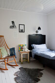 Rocking chair and black bed in child's bedroom