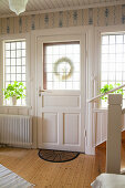Front door and lattice windows in Scandinavian country-house-style foyer