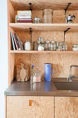 Shelves above sink in plywood fitted kitchen