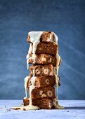 A stack of blondies with hazelnuts and white chocolate sauce
