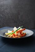Tomato risotto with spring onion and king prawns