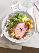 A portion of lamb with asparagus, broccoli and potatoes for Easter