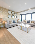 Glamorous living room in shades of Champagne with glass wall