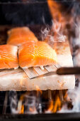Salmon being grilled on a salt slab