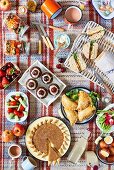 An English picnic with various savoury and sweet dishes (top view)