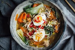 Pho soup with mushrooms, carrots, pak choi and eggs (Vietnam)
