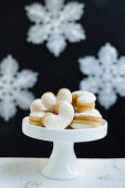 Meringue cookies filled with jam on a cake stand