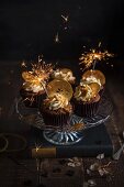 Apple and toffee cupcakes on a cake stand with apple crisps