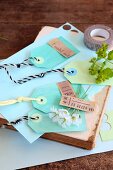 Hand-made paper tags in blue and green on old book