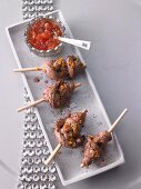 Lamb lollipops in gin and orange marinade with tomato jam