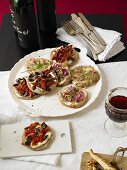 Rustic mini breads with three different toppings in a bistro