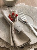 An Autumnal place setting with a serviette and a name tag