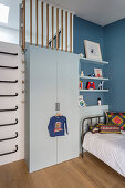 Wall bars next to wardrobe in boy's bedroom