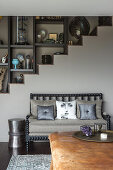 Curiosities on shelves lining staircase in living room