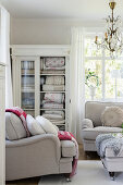 Blankets in lovely old glass-fronted cabinet in living room