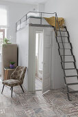 Metal ladder leading to sleeping platform above bathroom