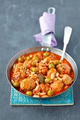 Pork meatball stew with green olives and beans