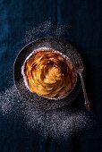 A small apple tart with icing sugar