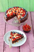 A sweet potato brownie cake with berries and flaked almonds