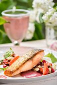 Roast salmon with pomegranate and strawberry dressing and strawberry and cucumber relish