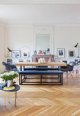 Modern dining table and upholstered benches in front of open fireplace