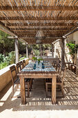 Set dining table and chairs on roofed terrace